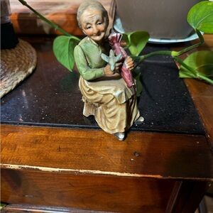 Charming Elderly Figurine with Doll